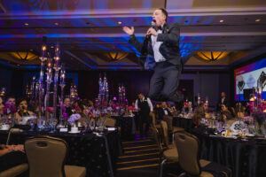 26 Auctioneer Jonny Bravo jumps at the $10000 donation (Photo by John Tran Photography)