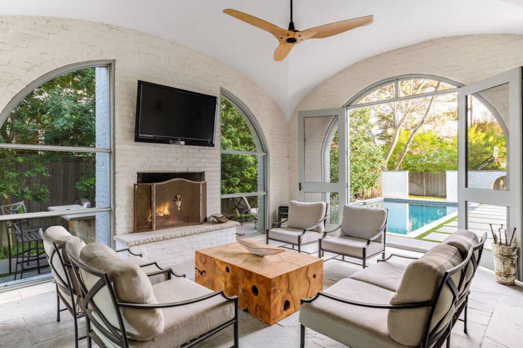 The screened-in covered patio is designed to function as an outdoor living room.