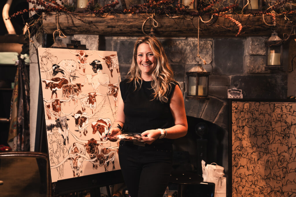 Inside Mule Alley, a local artist worked live, painting longhorns and rodeo scenes as guests wandered through. (Photo by Avin Park Photography)