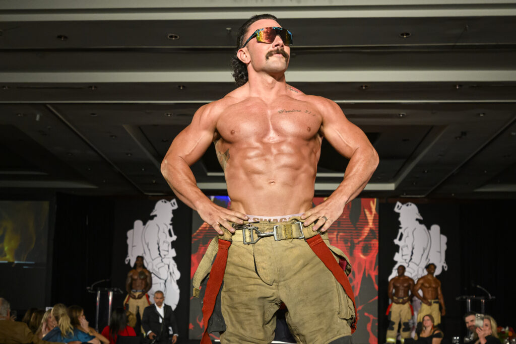 Fire Fighter Calendar model Daniel, Mr. April, strikes a pose at the Houston Fire Fighters 'Red Hot Gala' (Photo by Catch Light Group)