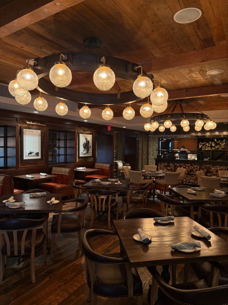 The Branding Room combines warmth and Western sophistication, with rich woodwork, soft lighting, and vintage photographs honoring Cattlemen’s storied legacy in the Stockyards. (Courtesy)