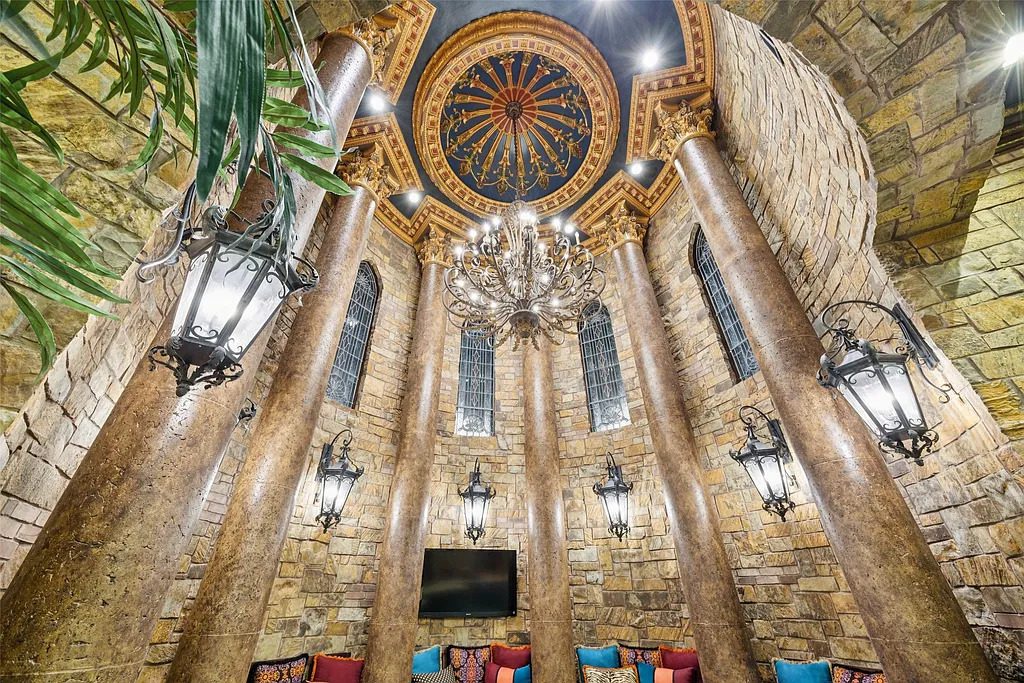 The rotunda lounge beneath the domed ceiling showcases stone columns, wrought-iron lanterns, and a chandelier centerpiece that evokes old-world grandeur. (Courtesy)