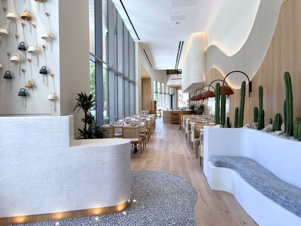 The 7,000-square-foot, two-story space was designed by Christina Wilburn of Gin Design Group. The interiors channel the warmth of Baja with wide-plank oak flooring and sculpted wood baffles that echo the movement of gentle ocean waves. Custom touches include a hand-finished mural of the Pacific coastline and banquettes upholstered in sun-washed terracotta and azure-blue hues. (Photo by Paula Murphy)