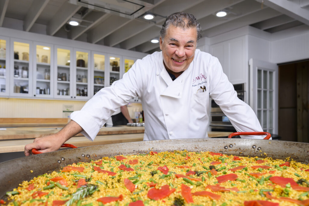 Chef Pedro Garcia presents paella at the 20th anniversary Delicious Alchemy banquet benefiting Recipe for Success Foundation (Photo by CatchLight Group)