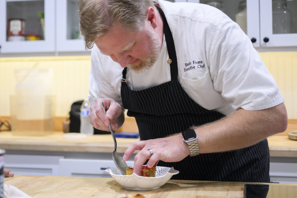 Chef Randy Evans working the 20th anniversary Delicious Alchemy banquet benefiting Recipe for Success Foundation (Photo by CatchLight Group)