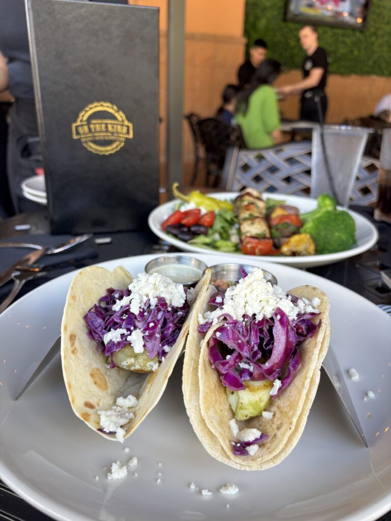 The fish tacos are made with grilled, wild-caught cod, topped with purple slaw and queso fresco.
