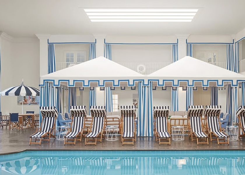 The indoor pool at the Palm Springs Yacht Club spa pairs nautical stripes with designer Jonathan Adler’s signature tongue-in-cheek luxury. (Photo by Parker Palm Springs)