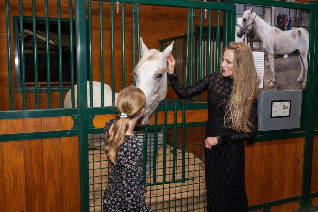 Penny Parker and Amber Bernhardt meeting horses at Houston SPCA's 5th Annual Howl-O-Ween Ball (Photo by Jacob Power)