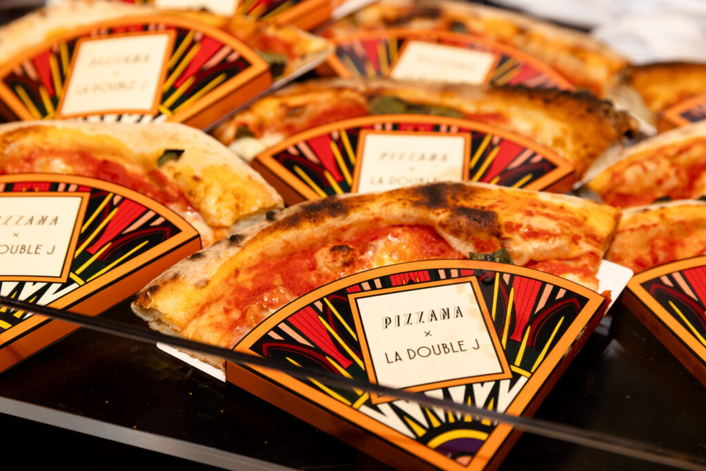 Pizzana delighted the crowd by delivering pizzas in custom La DoubleJ-branded sleeves. (Photo by Kaitlin Saragusa Kellerman)