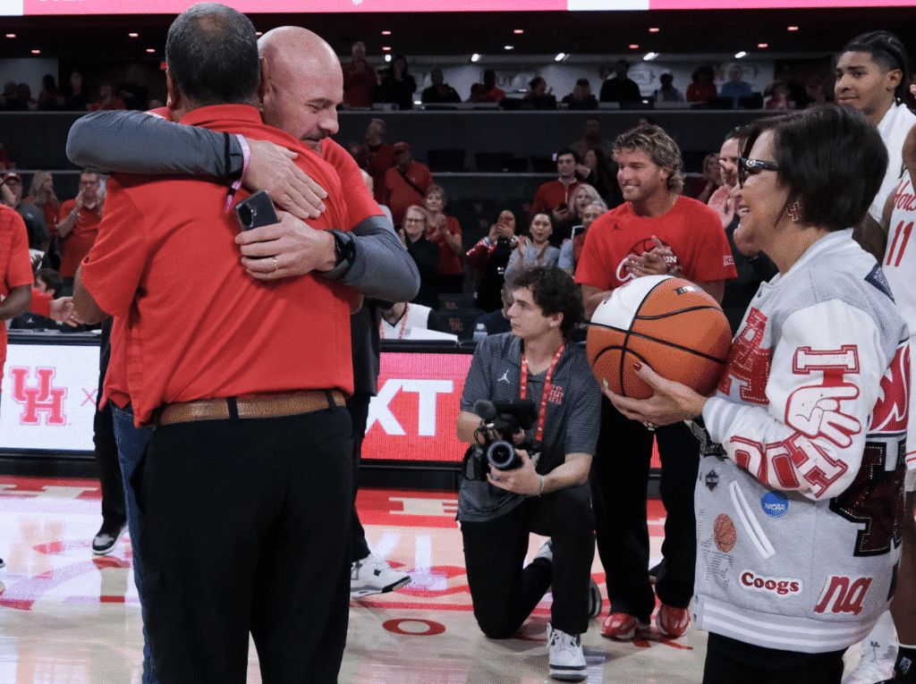 University of Houston coach Kelvin Sampson wraps his former Montana Tech player Joe McClafferty up in a hug. (Photo by F. Carter Smith)