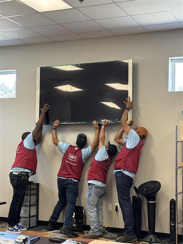 Lowe's employees personally purchased and installed two televisions at Beacon Access Center. (Photo by Project Beacon)