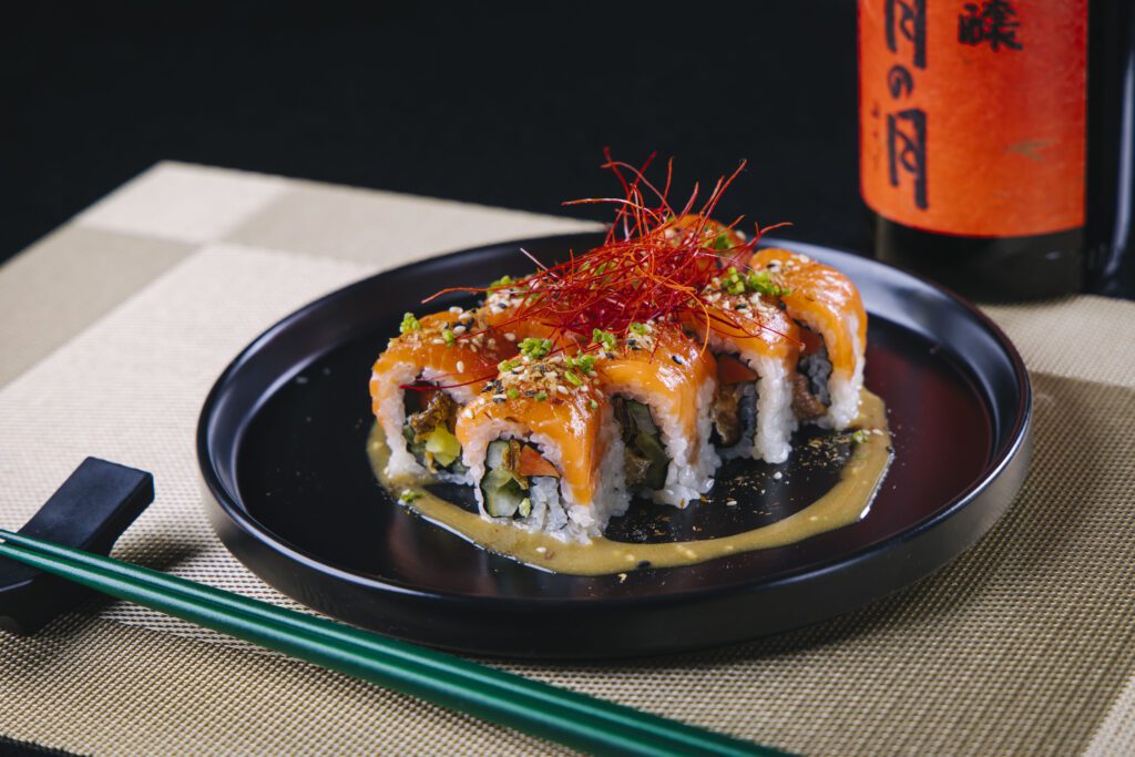The Cowboy Kiss roll blends Texas, Japanese, and Korean influences with pickled daikon radish and crisp salmon skin for texture and balance. (Courtesy)