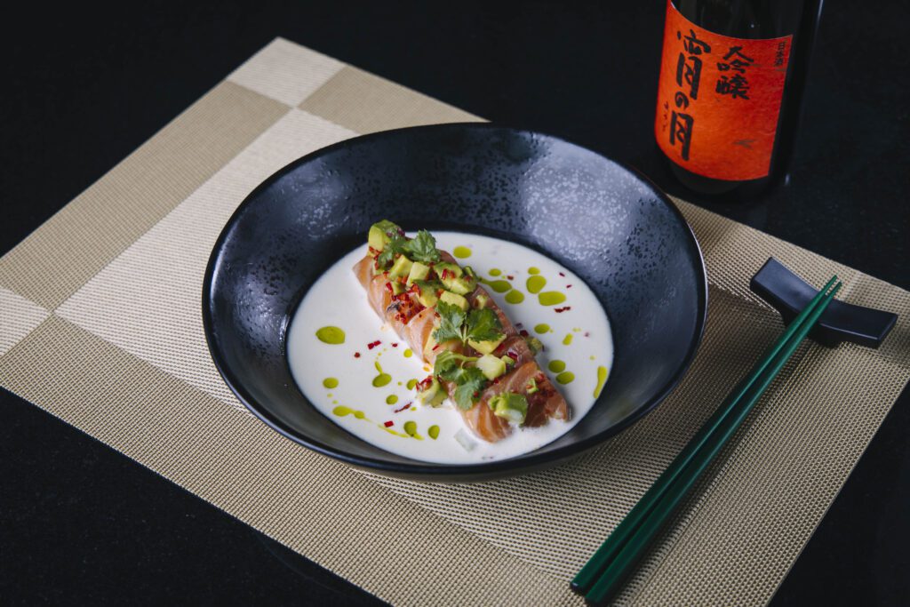 The Salmon Crudo features yuzu leche de tigre, jalapeño, cucumber, avocado, and chili. (Courtesy)