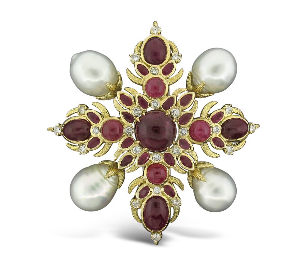 Hutton Wilkinson for Tony Duquette pendant brooch in 18K gold with ruby, pearl, and diamond, price upon request, at Neiman Marcus, Dallas; Saks Fifth Avenue, Houston; Cayen Collection, Carmel-by-the-Sea; Marissa Collections, Palm Beach.
