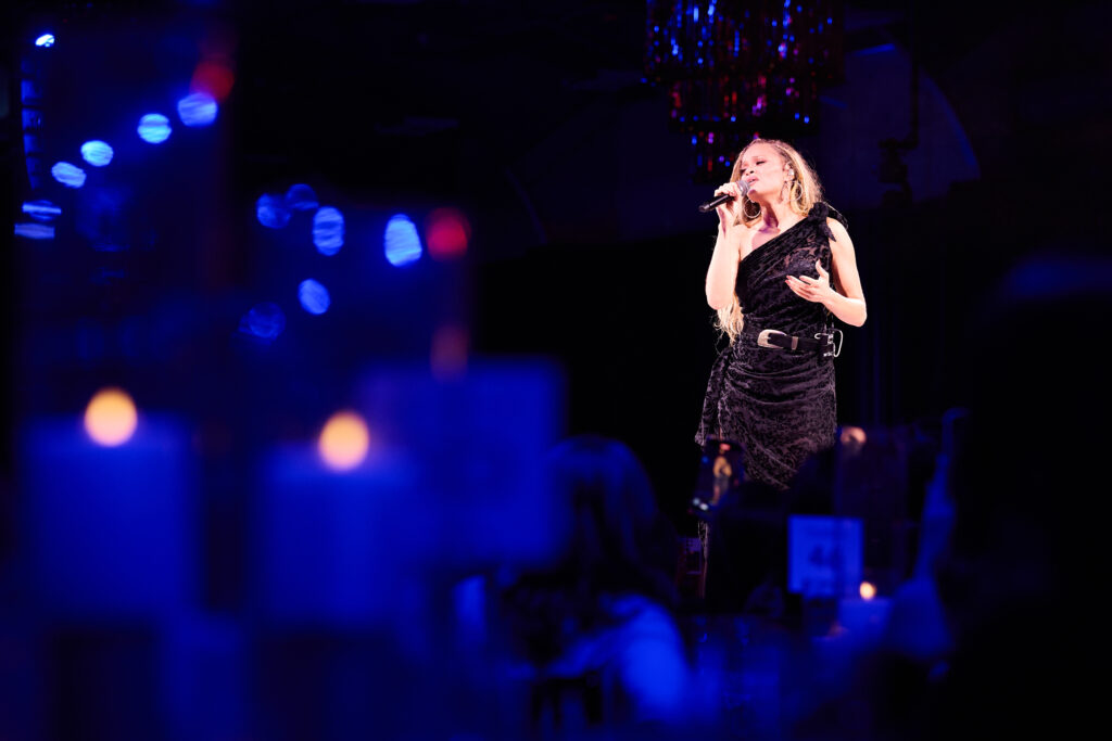 Andra Day performs at the Patron Dinner. (Photo by Gabe Wolf)