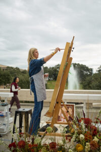 Austin artist Brittany Atkinson painting a Lone Star Cowgirl at the Lucchese pop-up during the Cotton Tailgate; photo courtesy of Cotton Holdings