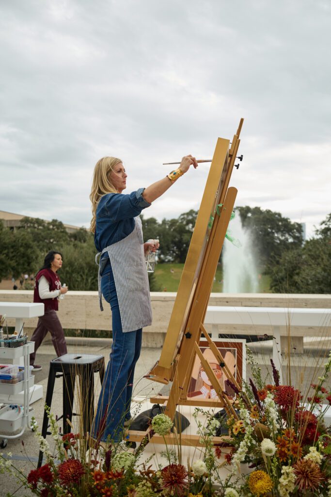 Austin artist Brittany Atkinson paints a Lone Star cowgirl at the Lucchese pop-up during Cotton Holdings' Lone Star Showdown tailgate (Photo by Photos Courtesy of Cotton Holdings)