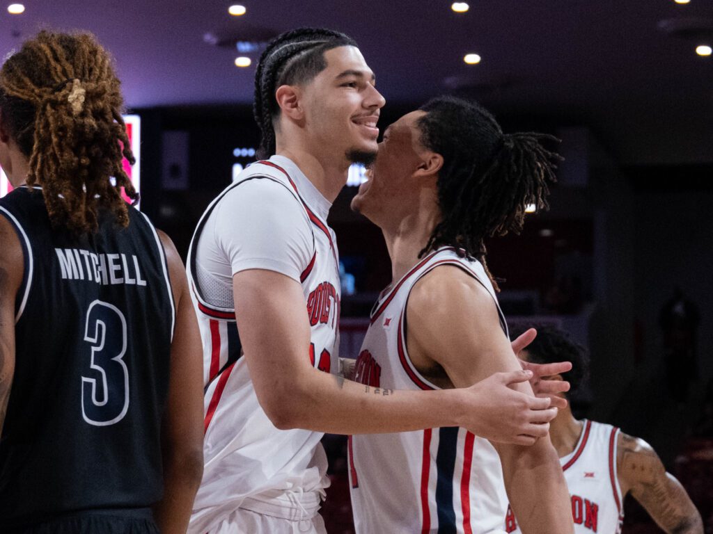 University of Houston center Jacob McFarland received an embrace from Isiah Harwell in his happy comeback moment. (Photo by F. Carter Smith)