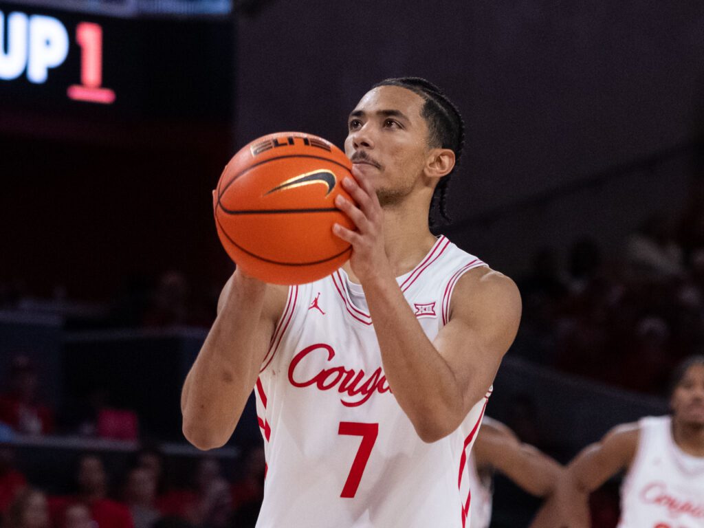 University of Houston point guard Milos Uzan keeps the offense rolling by finding the open man. (Photo by F. Carter Smith)
