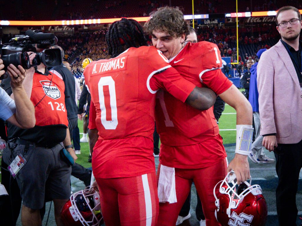 University of Houston quarterback Conner Weigman and wide receiver Amare Thomas share an embrace. (Photo by F. Carter Smith)