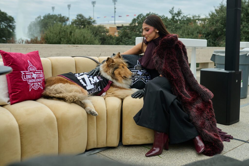 Zinat Ahmed shares a moment with Texas A&M University mascot Reveille at Cotton Holdings' Lone Star Showdown tailgate (Photo courtesy of Cotton Holdings) (Photo by Courtesy of Cotton Holdings)