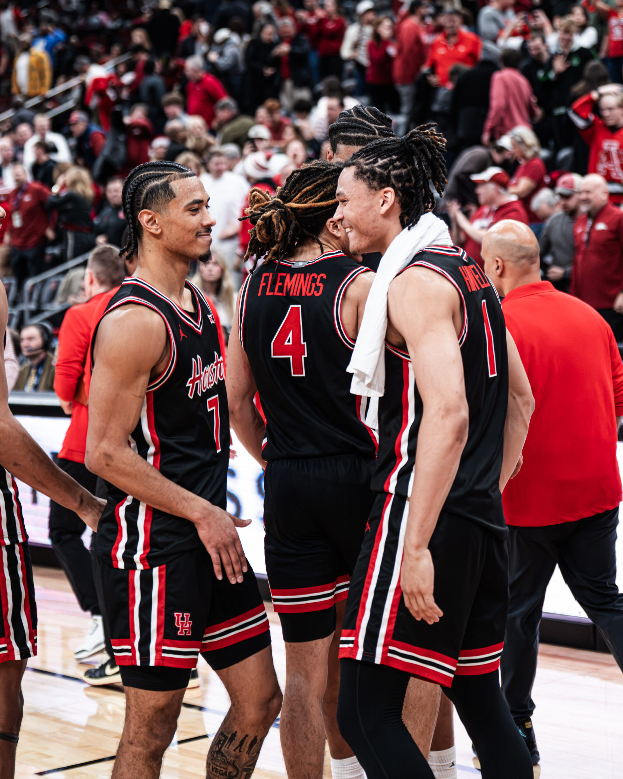 University of Houston guards Milos Uzan and Isiah Harwell celebrate the win over Arkansas.
