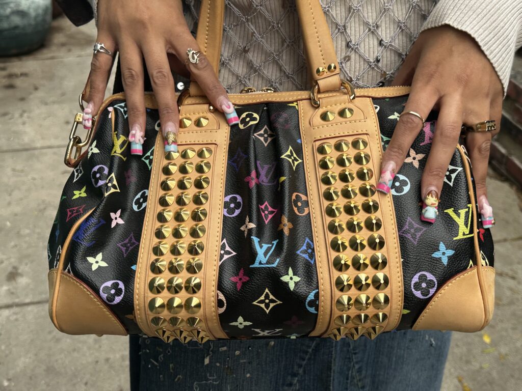 Louis Vuitton Monogram Multicolor Courtney MM handbag. This limited-edition, collectible bag was part of an iconic collaboration between artist Takashi Murakami and Louis Vuitton, first introduced in 2003, and is typical of the luxury handbags shoppers might discover at 2nd Street USA.