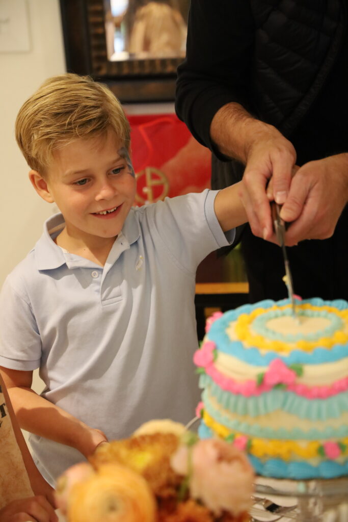 Beaux is excited to serve the cake during Modern Manners, but he is even more excited to taste the cake. 