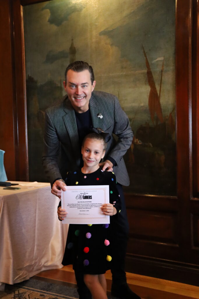Blayke accepts her graduation certificate from Chuck Steelman during the breakfast at The Crescent Club. 