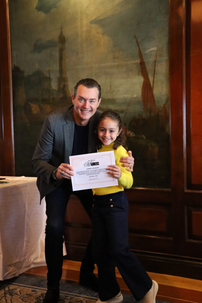 Gabriela graduates and receives her certificate from class creator Chuck Steelman. 