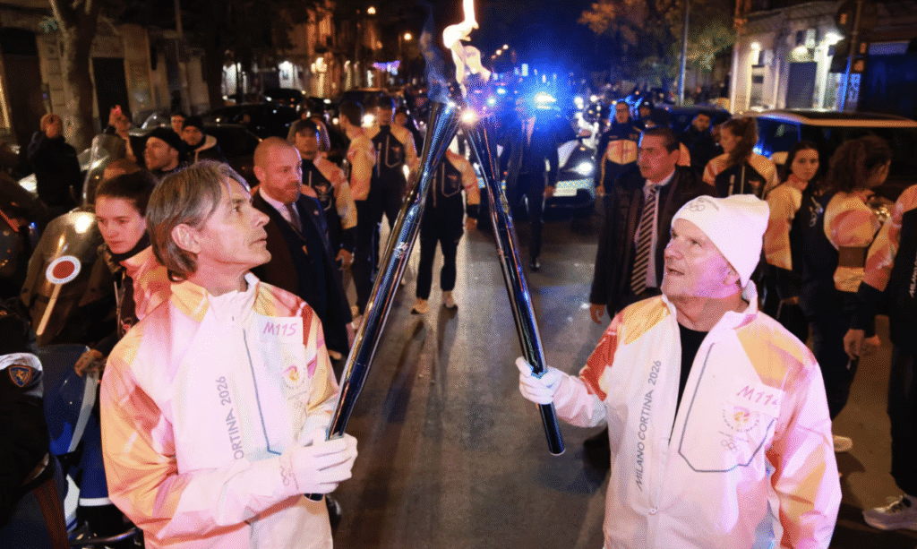 US Ambassador to Italy Tilman Fertitta passes the Olympic torch to Italian soccer icon Filippo Inzaghi during the Olympic relay in Sicily. (Olympic.com photo)