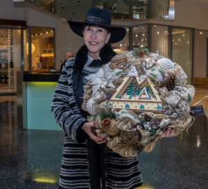 PaperCity’s Shelby Hodge selects the winning wreath by Christina Sacco for J. Patrick Homes at the Decorative Center Houston holiday wreath event benefiting the Salvation Army.