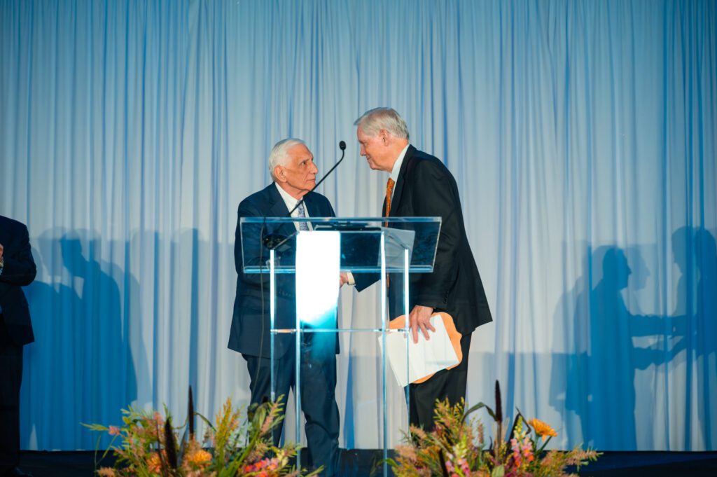 Retired Apache Corporation chairman and CEO Steve Farris presents the Raymond Plank Award for Visionary leadership to Corby Robertson Jr.