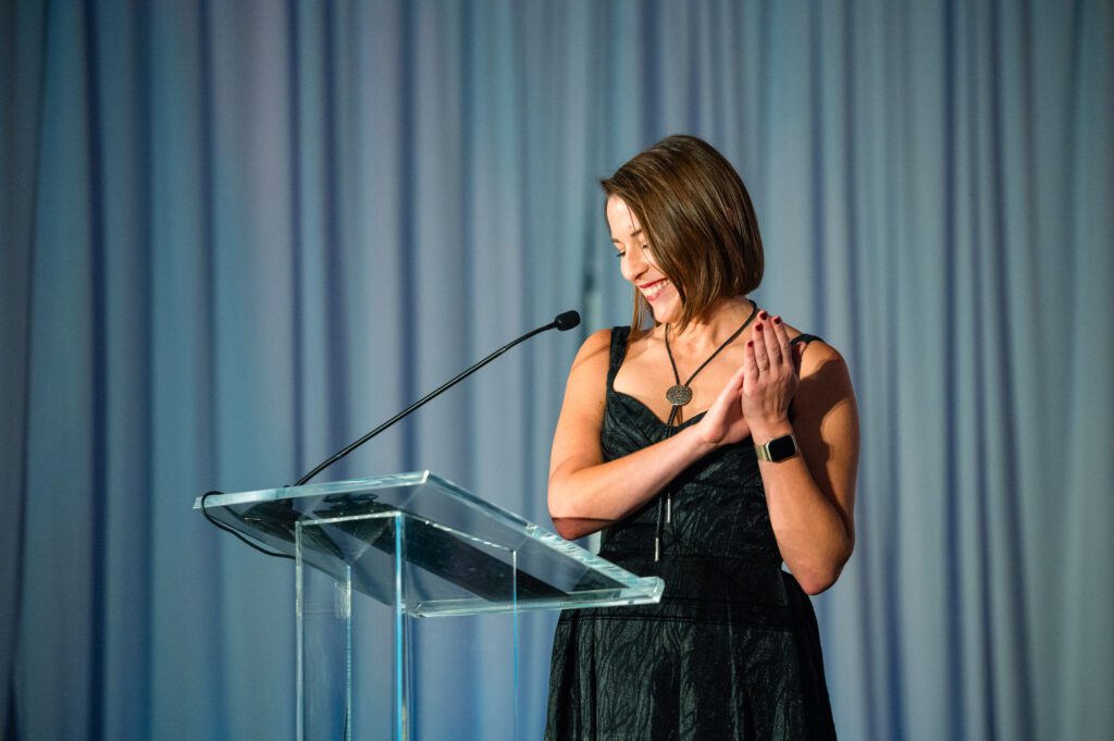 Ucross president and executive director Caitlin Addlesperger applauds guests at the POST Houston gala.