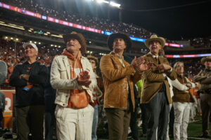 Woody Harrelson, Matthew McConaughey and UT Athletic Director Chris Del Conte at the Cotton Holdings Lone Star Showdown; photo courtesy of Cotton Holdings
