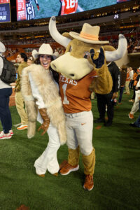 Zinat Ahmed with University of Texas Mascot Hook ‘Em; photo courtesy of Cotton Holdings