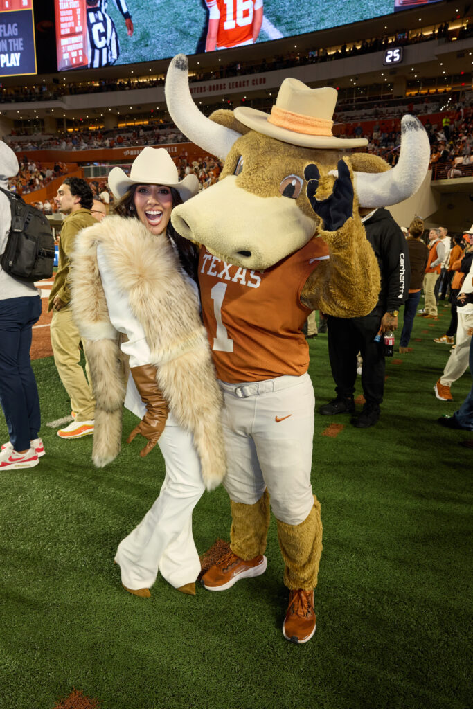 Zinat Ahmed with the University of Texas mascot Hook 'Em on the sidelines at the Lone Star Showdown (Photo Courtesy of Cotton Holdings) (Photo by Courtesy of Cotton Holdings)
