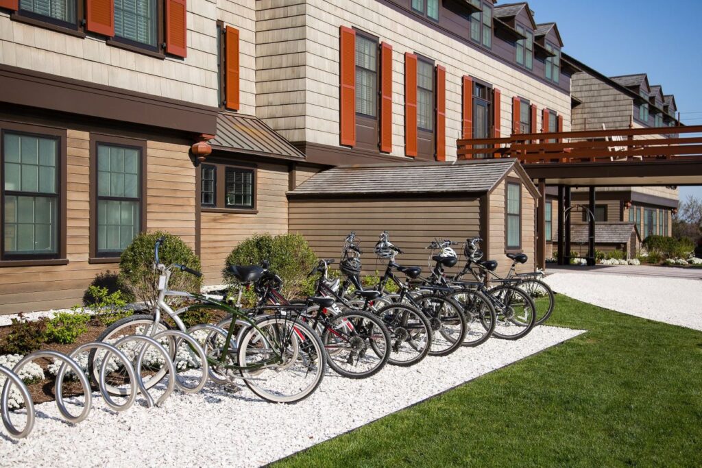 Covered in red cedar shingles, the Inn's exterior is accented by dark brown trim and red shutters. Bicyles are lined up. Hyndrangeas are blooming and blowing in the breeze. (Courtesy)