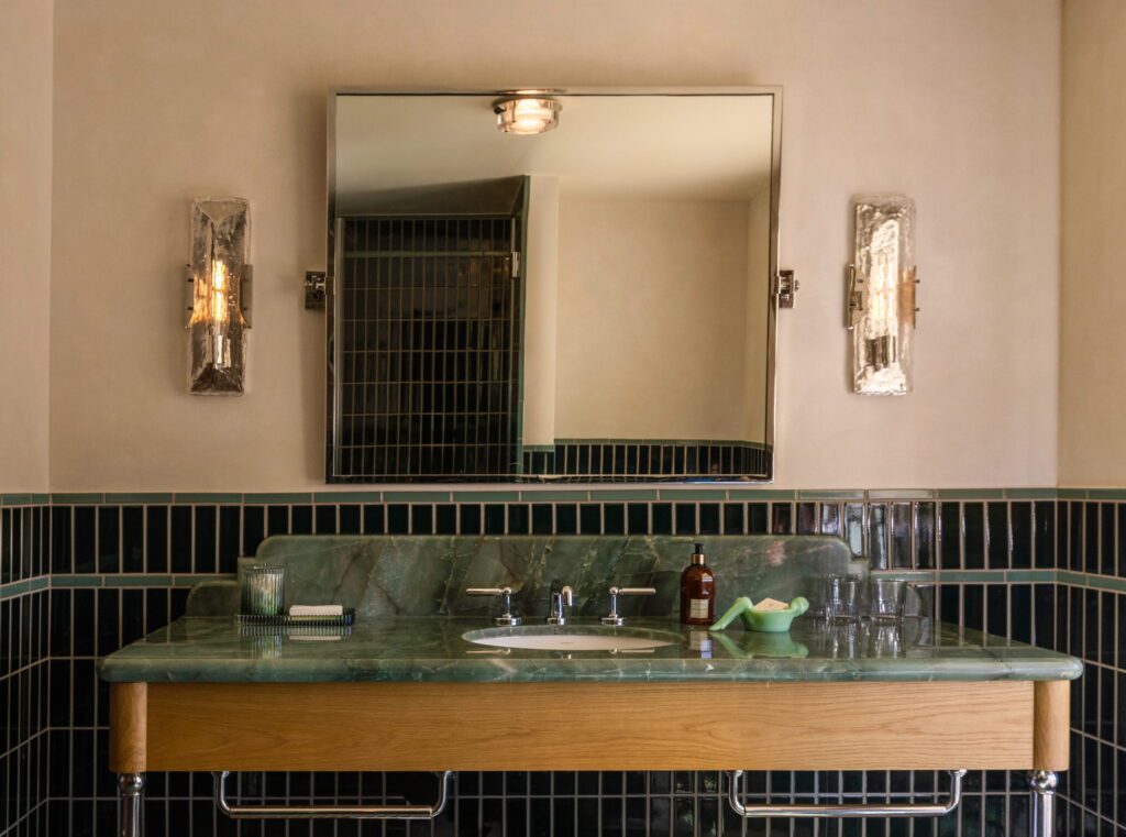 A bath swathed in Fireclay tile with onyx vanity. (Photo by Julie Soefer)