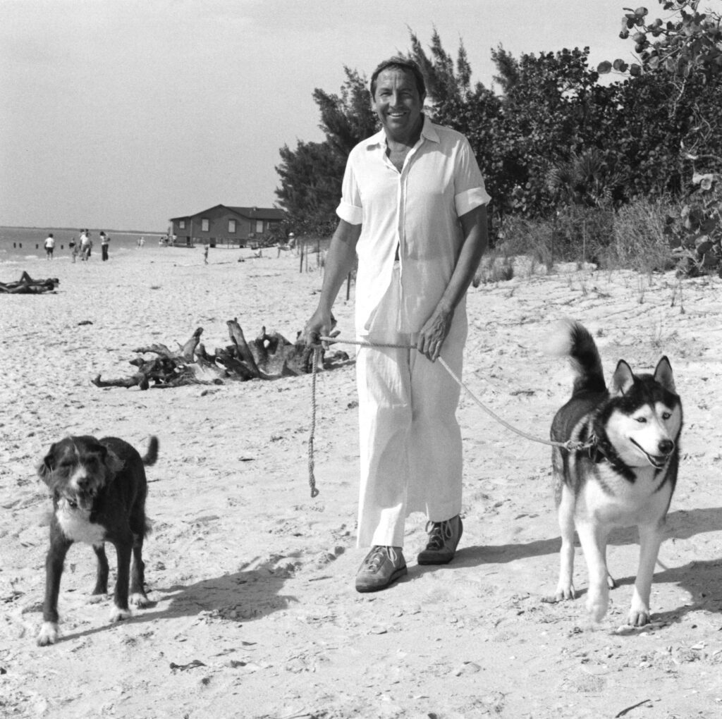 Rauschenberg walking his dogs Kid and Star on the beach, Captiva, Florida, circa 1984 (Robert Rauschenberg Foundation Archives, New York. Photo by Terry Van Brunt.)