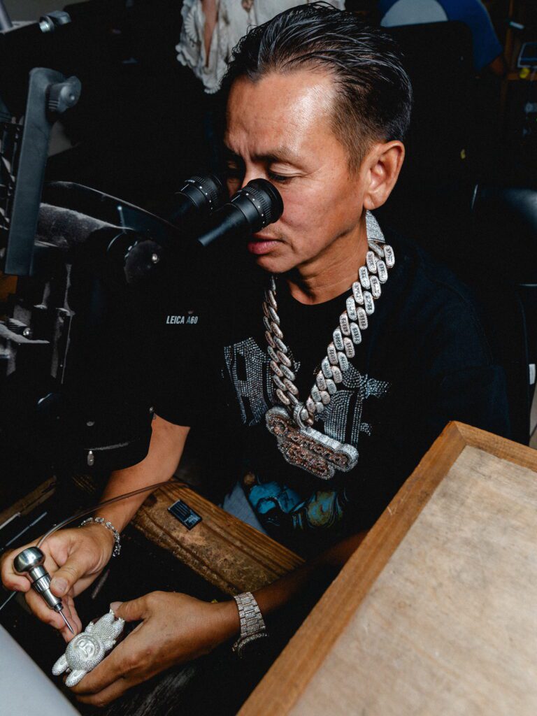 Grillz master Johnny Dang at work on a bejeweled Labubu. Celebrity clients flock from all continents to his Houston Richmond Ave HQ. (Photo by Antonio Chicaia)