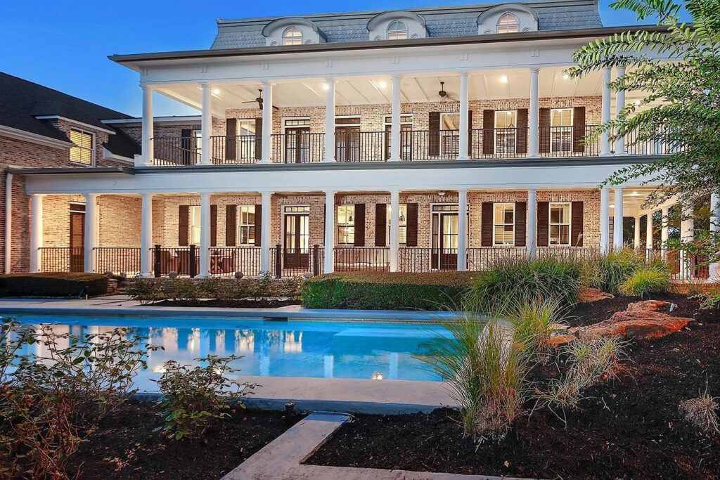 Double-decker wrap-around porches? Say no more. 30 East Bay is a Woodlands backyard to swoon over.