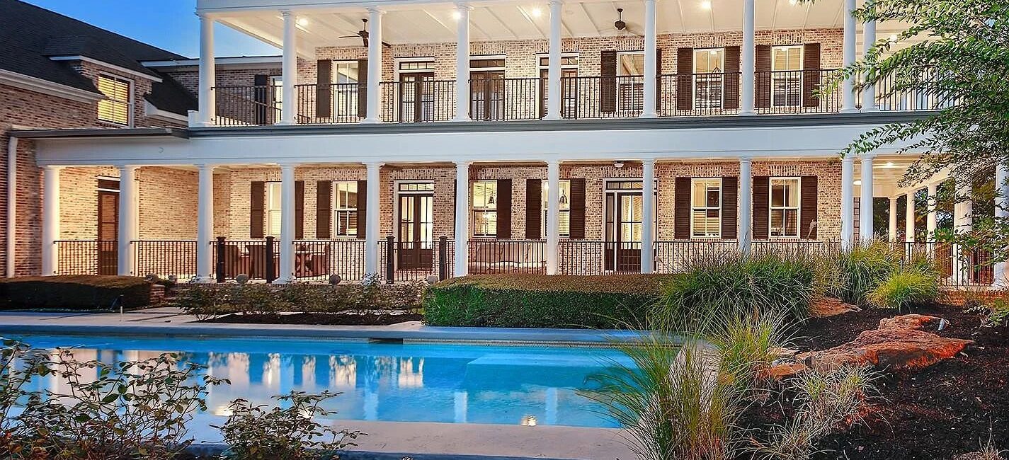 Double-decker wrap-around porches? Say no more. 30 East Bay is a Woodlands backyard to swoon over.