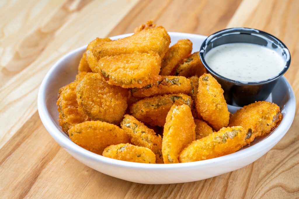 Chicken N Pickle's menu offers fried pickles and hearty chicken dishes. (Courtesy)