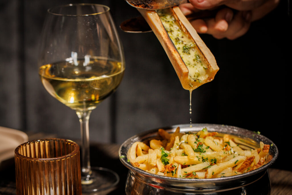 The Saint's side of fries comes with bone marrow, melted tableside. (Photo by Samantha Marie Photography)