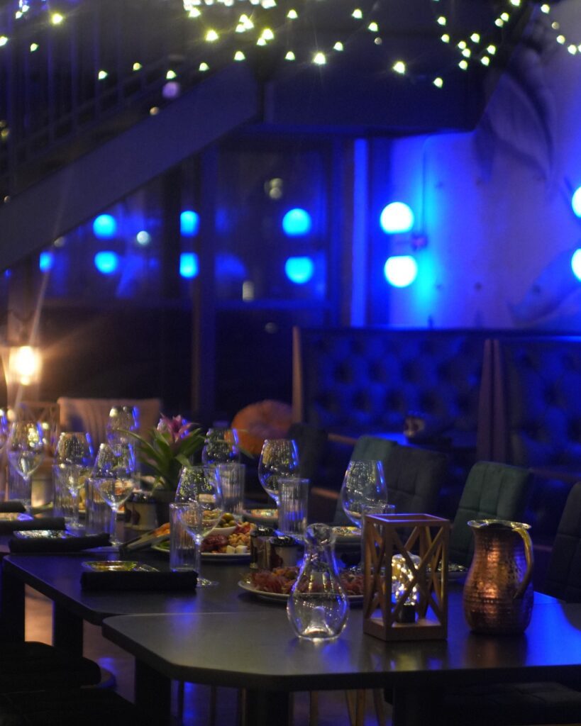 With velvet seats, horseshoe booths along the back wall, string lights overhead, and a wash of soft purple light throughout, Brooklyn's lends a warm, lounge-like atmosphere. (Courtesy)
