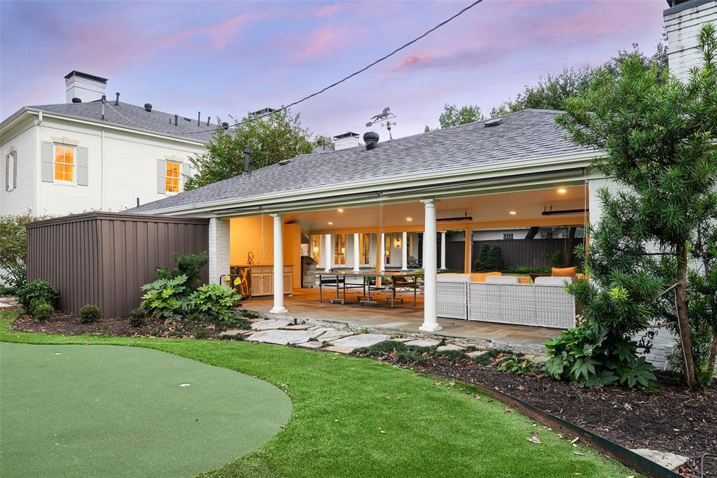 The backyard features a party cabana, outdoor living area, built-in grill, kitchenette, wood-burning fireplace, and a full bathroom. (Photo by Compass RE Texas, LLC)