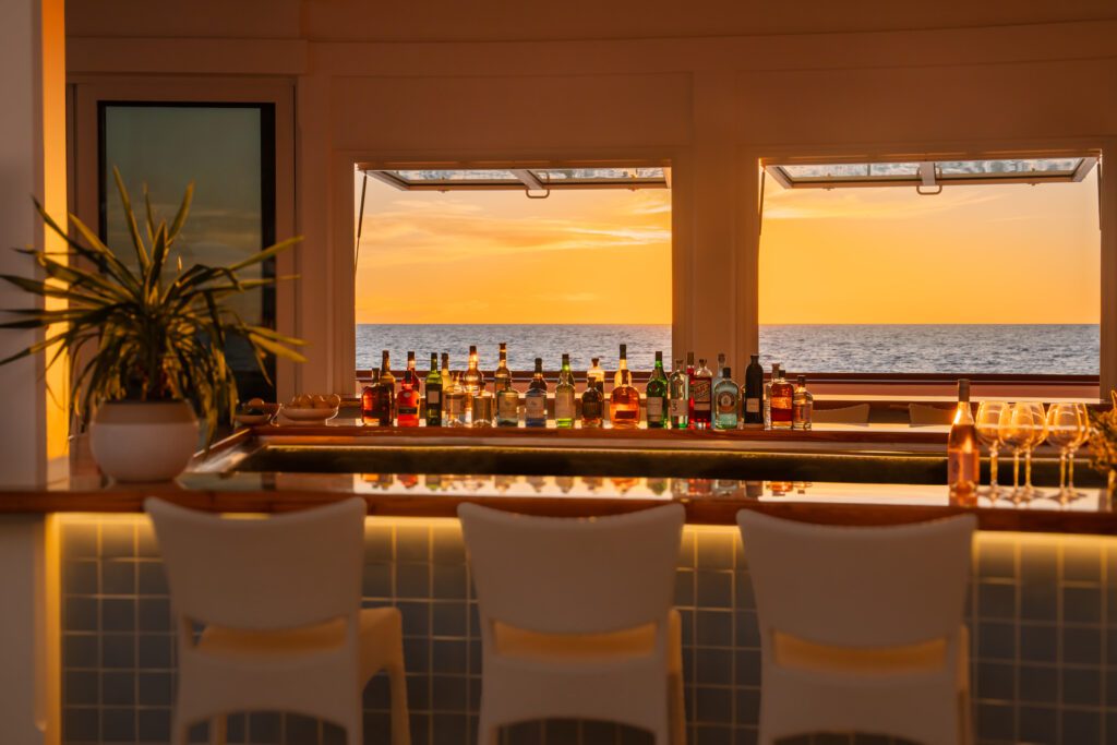 Everyone gathers at Sunset Bar for cocktails during golden hour. (Photo by Naples Beach Club)