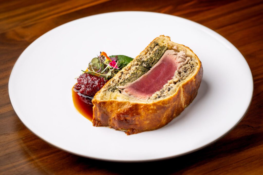 'ULU's Ahi Tuna "Wellington" with Ali’i Mushrooms, Luau Leaf, and Foie Gras Bordelaise (Photo by Four Seasons Resort Hualalai)