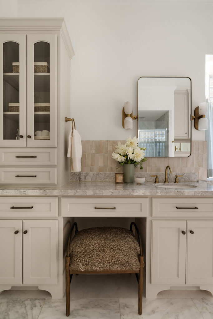 Bathroom storage is no longer cramped with the added cabinetry.  A warm paint tone puts the detail in the cabinets in the spotlight. (Photo by Madeleine Harper Photography)
